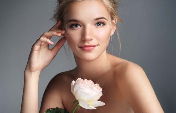 Beautiful, blonde woman with a white rose.